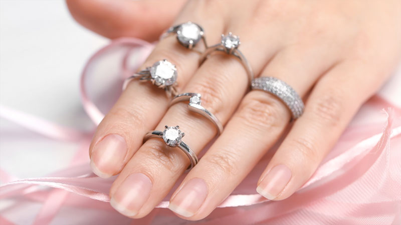 Woman wearing assorted diamond rings