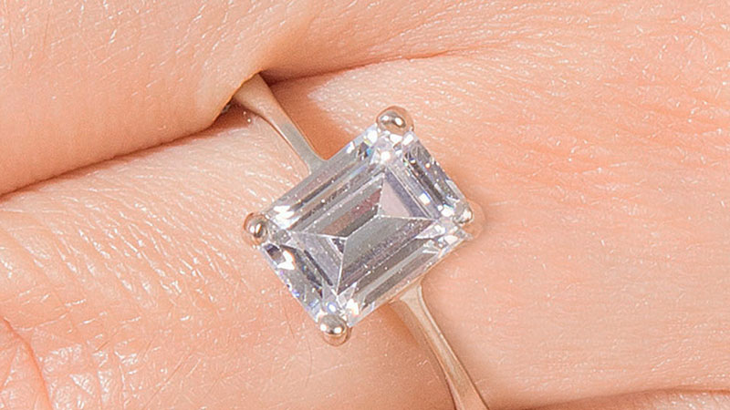 Engagement ring with an emerald cut center diamond shape.