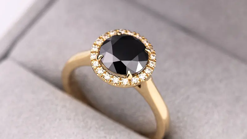 An engagement ring with a black fancy colored diamond center stone.
