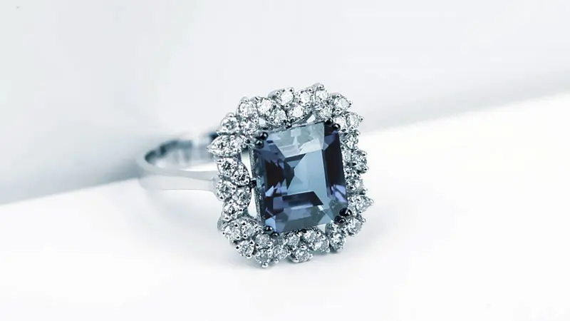 An engagement ring with fancy blue diamond center stone.