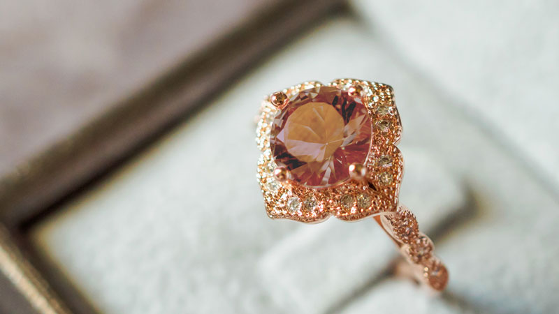 A rose gold engagement ring set with a brown fancy colored diamond.