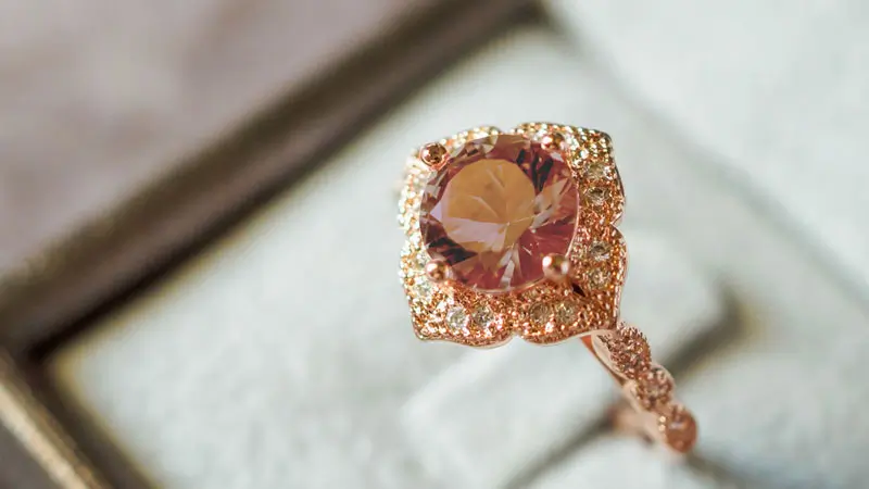 A rose gold engagement ring set with a brown fancy colored diamond.