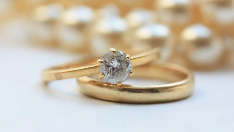A gray fancy colored diamond set in a yellow gold ring.