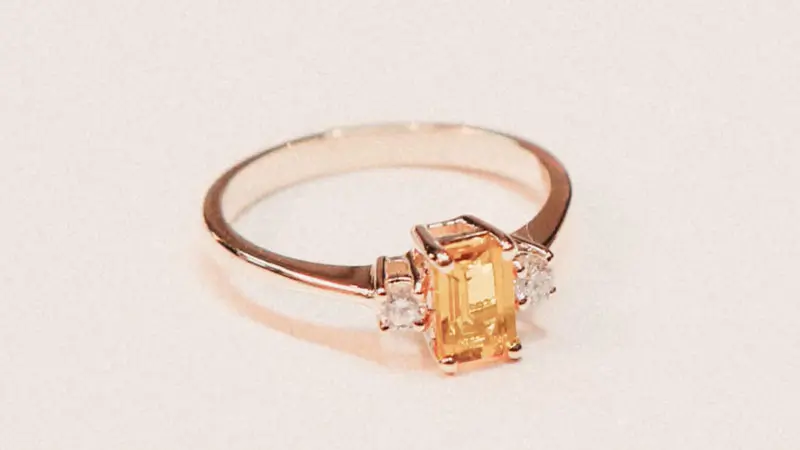 An orange fancy colored diamond engagement ring.