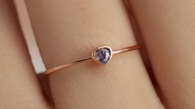A violet fancy color diamond engagement ring.