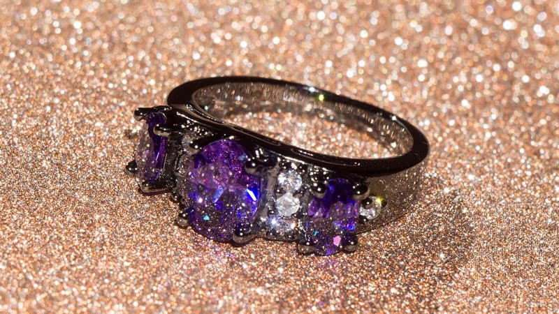An amethyst and black diamond ring set in black gold, a dark precious jewelry metal.