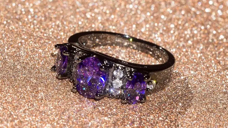 An amethyst and black diamond ring set in black gold, a dark precious jewelry metal.