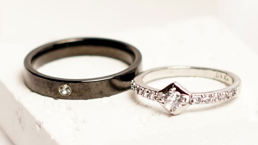 Two beautiful jewellery rings, each made with a different color material and set with white gems.