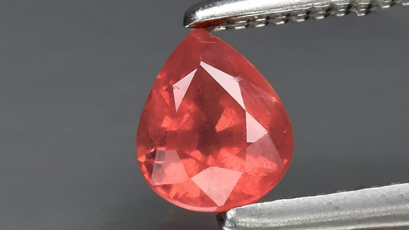 A pink-orange or salmon color padparadscha sapphire.