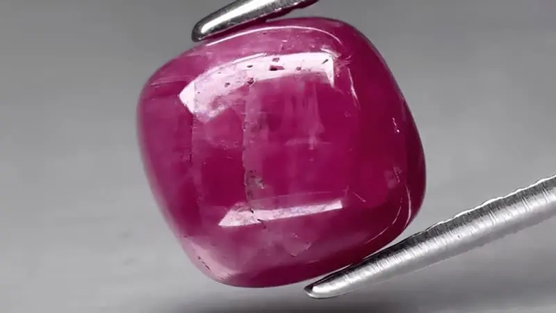 A natural ruby gemstone cabochon from southern India.