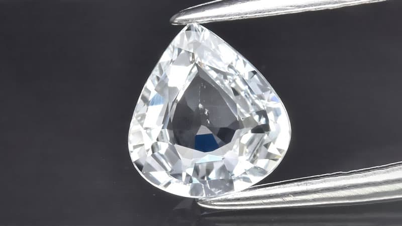 A closeup view of a white or colorless sapphire with brilliant sparkle.