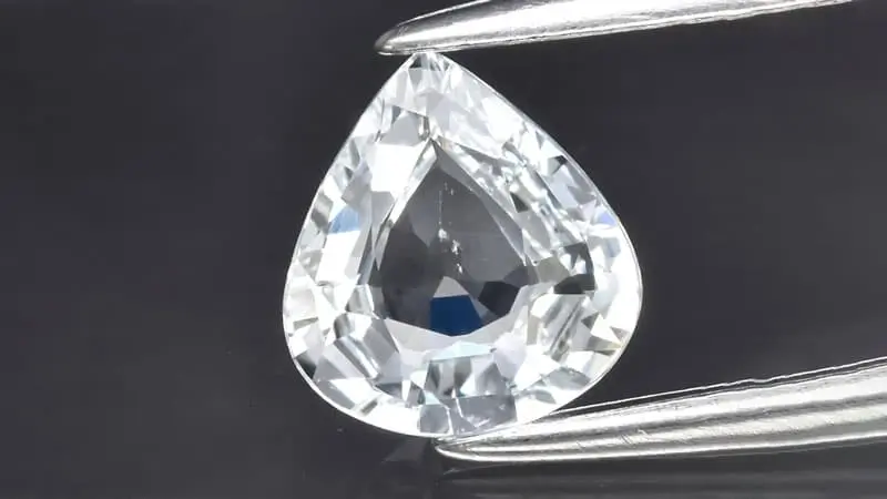A closeup view of a white or colorless sapphire with brilliant sparkle.