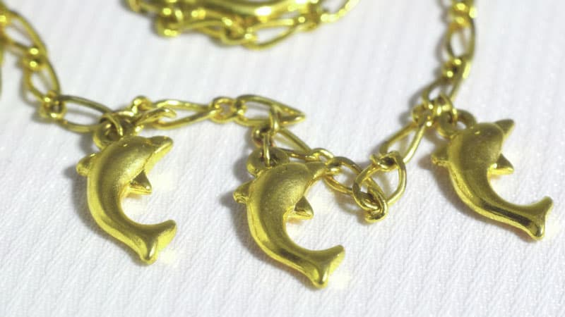 Golden dolphin charms on chains