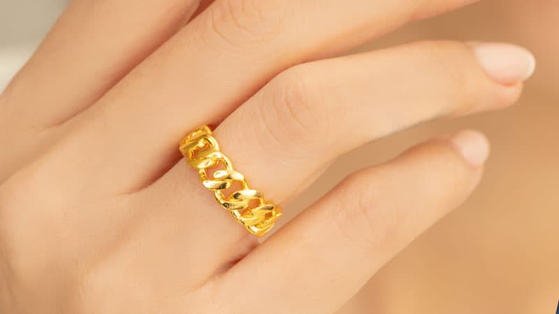 Fake gold plated ring on woman's finger